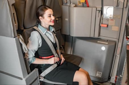Why Flight Attendants Sit on Their Hands During Takeoff Flight Attendants